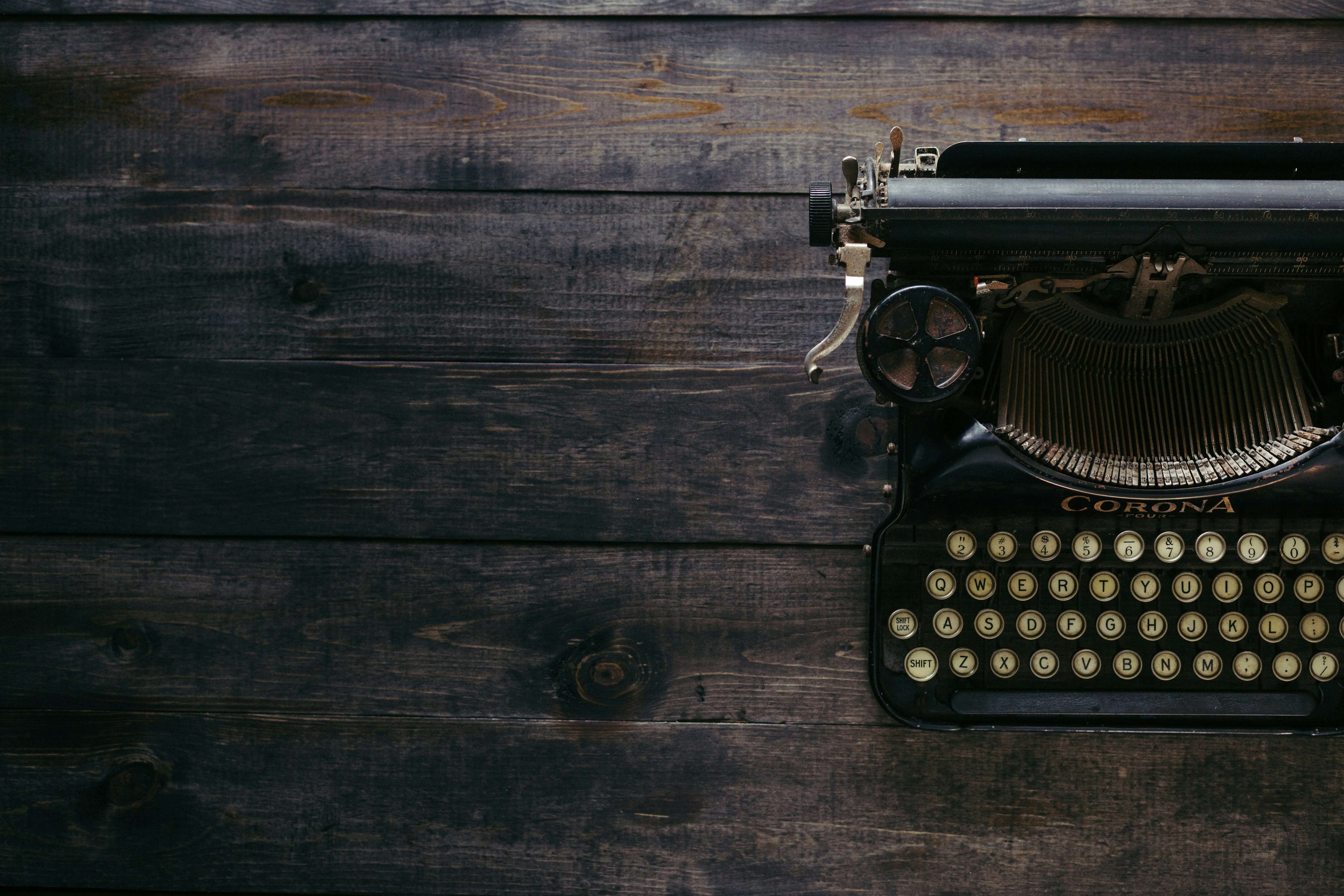 Stock image by Patrick Fore. Vintage typewriter on a dark wooden surface.